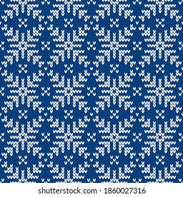 Christmas and New Year traditional knitted seamless pattern with snowflakes. Norwegian style sweater. Wool texture. Vector illustration. Holiday background.