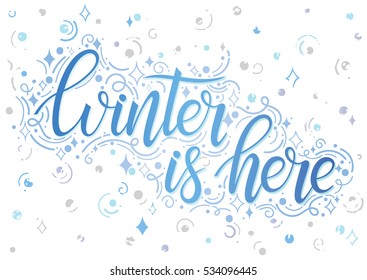 Christmas and New Year typography. Winter is here - Hand painted lettering with stylized snowflakes,swirls and sparkles. Seasons greetings card designs perfect for prints, flyers, cards and more.