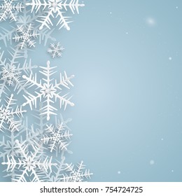 Christmas and New Years background Made of paper snowflakes and diamonds. Snowflakes on a blue background