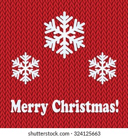 Christmas and New Year's background with place for your text.White snowflakes on a red knitted background