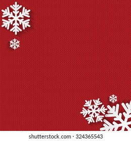 Christmas and New Year's background with place for your text.White snowflakes on a red knitted background