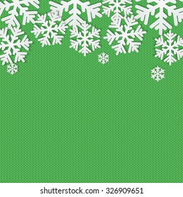 Christmas and New Year's background with place for your text.White snowflakes on a green knitted background