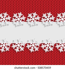 Christmas and New Year's background with place for your text.White snowflakes on a red knitted background