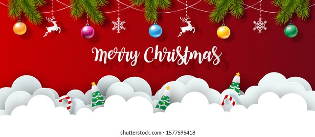 Christmas objects with Christmas lettering and pine leaves decorated on red background and white clouds in paper cut style. Beautiful Christmas greeting card in vector design.