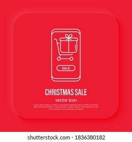 Christmas online shopping. Gift in shopping cart on smarphone screen. Thin line icon, Vector illustration.
