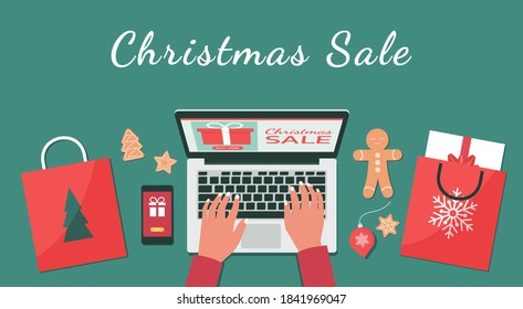 Christmas online shopping or winter holiday sale top view concept, human hand makes order on laptop screen with gift boxes and shopping bags, and text, flat lay vector illustration