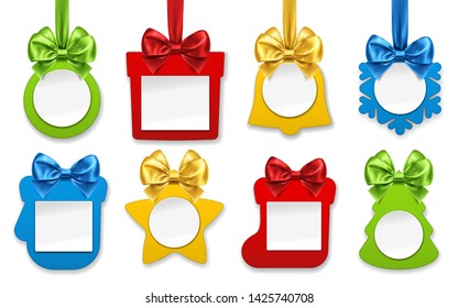 Christmas paper decorations. New year ornaments in form of star, sock for gifts, present, fir tree, jingle bell, ball toy, mitten, snowflake with flavor ribbon and bow knots.Winter holiday and festive