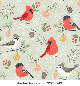 Christmas pattern with cute winter birds, mistletoe, holly berry, Christmas ornaments, pine cones and pine branches on snow background