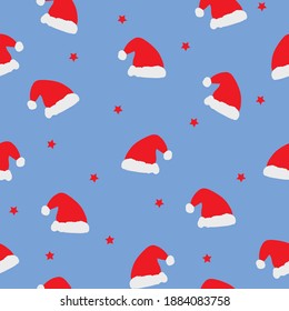 Christmas pattern for postcards and wallpapers. Santa hats on a blue background. Vector image.