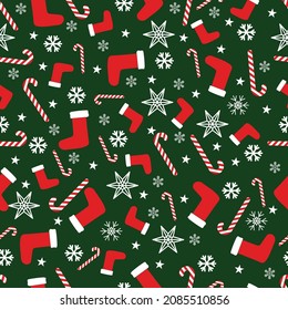 Christmas pattern. Christmas socks, lollipop (cane), white snowflakes on a green background. Vector graphics. Infinite pattern