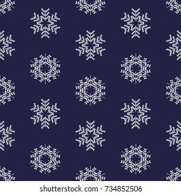 Christmas pattern of white snowflakes on blue background. Vector illustration.