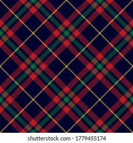 Christmas plaid pattern dark in red, green, blue, yellow. Seamless striped multicolored textured check plaid for skirt, blanket, duvet cover, gift wrapping, or other New Year festive textile print.