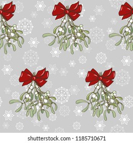 Christmas plants, mistletoe bouquet with red bow on snowflake background, seamless vector illustration