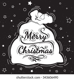 Christmas postcard with calligraphy, lettering, hand written on chalkboard. Merry Christmas - quote in a Santa Claus bag . Design element for congratulation cards, banners and posters