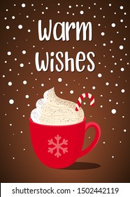Christmas postcard with handwritten text "warm wishes" and red mug with hot chocolate, whipped cream and Lollipop cane on brown background with snowflakes