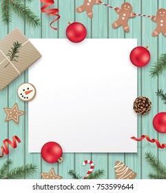 Christmas poster template with gift box, ribbon, Christmas ornaments, pine cones, cookies, fir branches and a white blank paper for your text