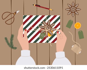 Christmas preparation concept featuring gift wrapping from top view with girl hands. Vector illustration for holiday designs, festive promotions and seasonal packaging visuals