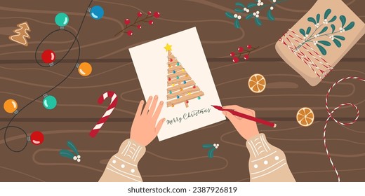 Christmas preparation cozy background. Hands writing a greeting card. New Year's Eve background with gift, garland, natural decorations. Top view illustration in flat style