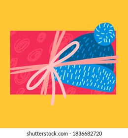 Christmas present from above flat vector illustration. Wrapped gift box with knitted hat