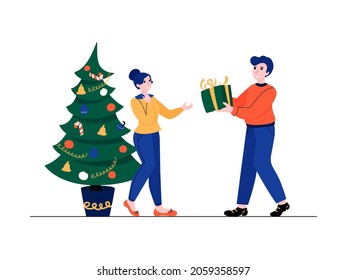 Christmas present. Man holds a gift box in his hands. A woman receives a gift from her husband.