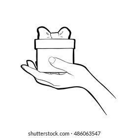 Christmas present. Vector sketch of gift box in hand. Hand drawn illustration isolated on a white
