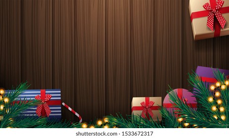 Christmas presents, Christmas tree branch and yellow garland on wooden table, top view. Wooden Christmas background for discount banner or greeting postcard