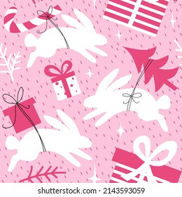 Christmas rabbits seamless pattern. New year bunnies. Sweet vector repeating pattern with hare silhouette carrying present boxes, Christmas tree and candy canes.