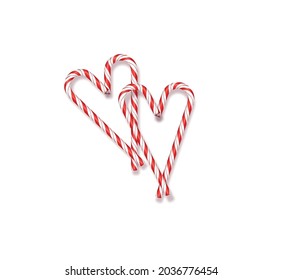Christmas red and white lollipops on a white background lined in the shape of Christmas hearts and Valentine's Day gift