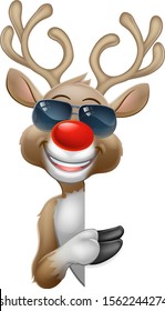 Christmas reindeer red nosed deer cartoon character wearing cool shades or sunglasses peeking around a sign and pointing at it