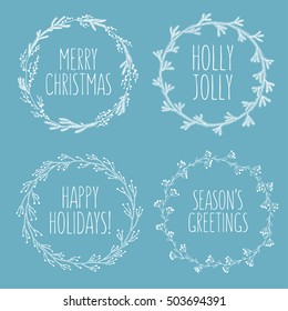 Christmas related hand drawn floral wreaths set. Greeting christmas quotes. Holly jolly. Happy holidays. Seasons greetings. Decorative design elements for postcards. Vector vintage illustration.