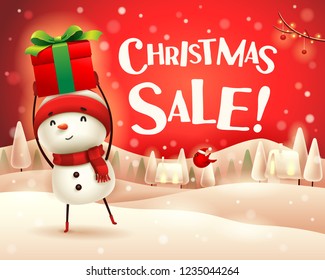 Christmas Sale! Cheerful snowman holds up gift present in Christmas snow scene winter landscape.
