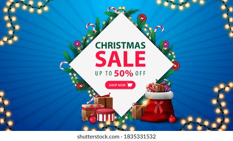 Christmas sale, discount banner with diamond-shaped frame of Christmas tree branches and garlands around offer, pink button and garland frame on blue background