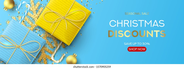 Christmas sale holiday web banner. Festive background with realistic blue and yellow gift boxes, candy canes, Christmas balls, gold confetti and snowflake. Vector illustration. Xmas promo header.