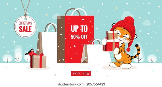 Christmas sale horizontal discount banner design. Cute cartoon tiger in red hat holding gift boxes, standing at big bags, snowy landscape decoration for flyers, poster, web, card vector illustration