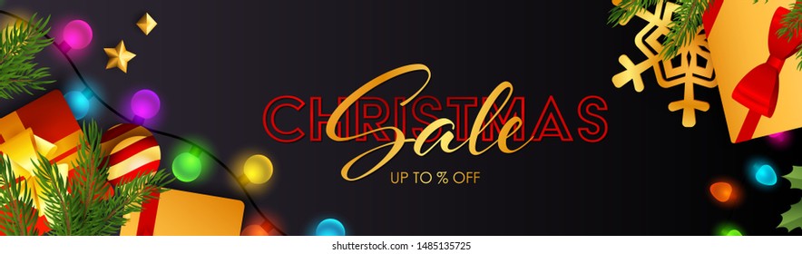 Christmas Sale lettering with sparkling colorful light bulbs, presents and fir branch on dark blue background. Up to percent lettering can be used for posters, leaflets, announcements