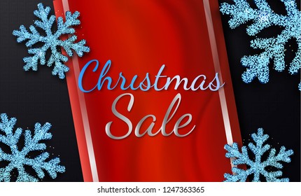 Christmas sale. Promotion Poster or banner with realistic red shiny ribbon and 
blue ice snowflake on black background. Promotion or shopping design template for Christmas or New Year.Vector EPS10