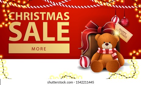 Christmas sale, red discount banner with garlands, button and present with Teddy bear near the wall