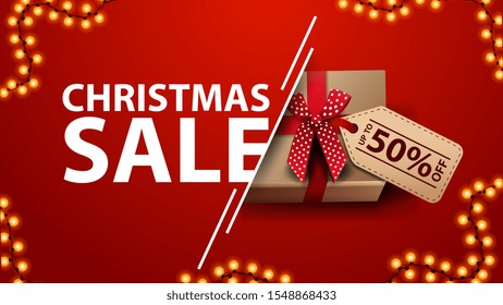  Christmas sale, red discount banner with garland and present with bow and price tag, top view