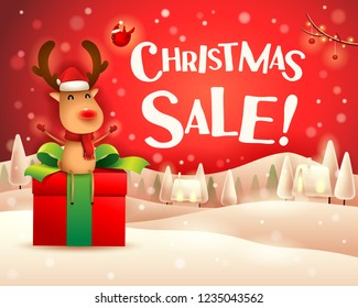 Christmas Sale! The red-nosed reindeer sit on gift present in Christmas snow scene winter landscape.
