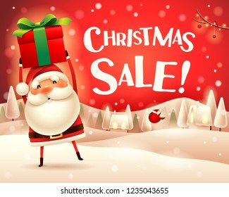 Christmas Sale! Santa Claus holds up gift present in Christmas snow scene winter landscape.