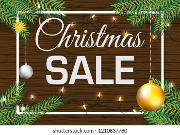 Christmas sale vector card with ball pine branch on brown wood background