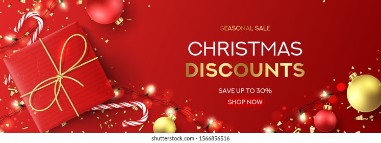 Christmas sale web banner template. Holiday background with red gift box, light garlands, Christmas golden balls, confetti and candy canes. Vector illustration. Happy New Year poster.