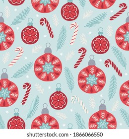 Christmas seamless pattern with balls, candy cane, fir branches, snow on light blue background. Scandinavian style. Perfect for holiday invitations, winter greeting cards, wallpaper and gift paper
