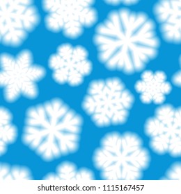 Christmas seamless pattern of big blurry snowflakes, white on light blue background