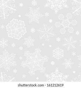 Christmas seamless pattern from big and small white snowflakes on gray background