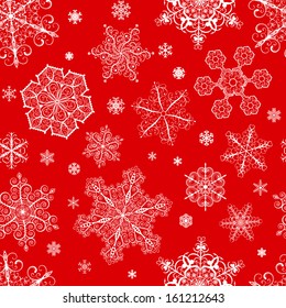 Christmas seamless pattern from big and small white snowflakes on red background