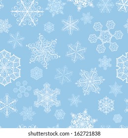 Christmas seamless pattern with big and small white snowflakes on cyan background
