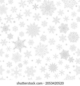 Christmas seamless pattern of big and small complex snowflakes in gray and white colors. Winter background with falling snow