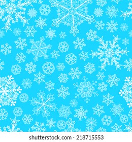 Christmas seamless pattern of big and small snowflakes, white on light blue