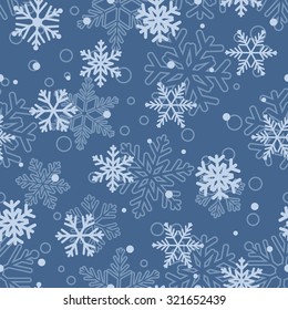 Christmas seamless pattern of big and small snowflakes, in light blue colors